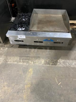 Comstock Castle stainless steel 2-burner griddle range, model FHP36-24, with back & side splash, on legs, natural gas powered.