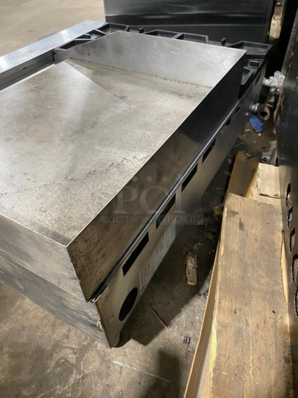 Comstock Castle 2-burner stainless steel griddle range, model FHP3624, with back and side splash. Natural gas, on legs.