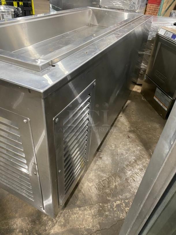 Commercial stainless steel cold pan salad bar with four drawers, refrigerated, on casters, excellent condition.
