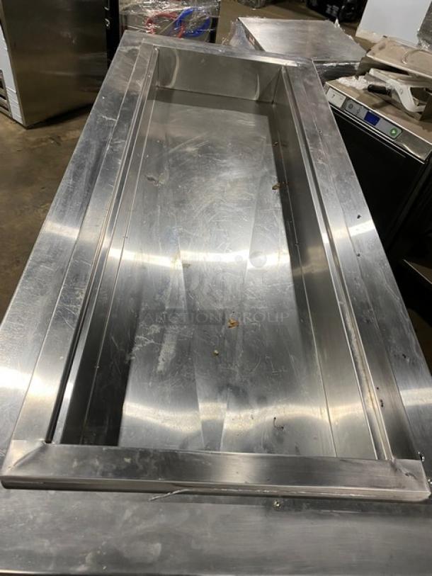 Commercial stainless steel refrigerated cold pan salad bar with four drawers, on casters. Used condition.