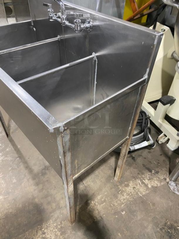 Commercial stainless steel 3-compartment prep sink with backsplash, swivel swing-spout faucet, mounted on legs, used condition.