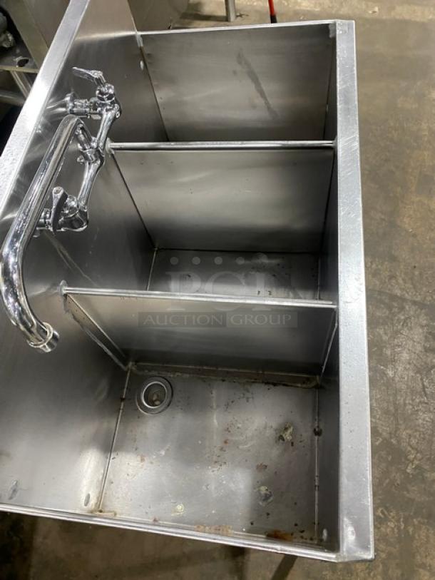 Commercial stainless steel 3-compartment prep sink with backsplash, swivel swing-spout faucet, and sturdy legs. Small signs of wear.