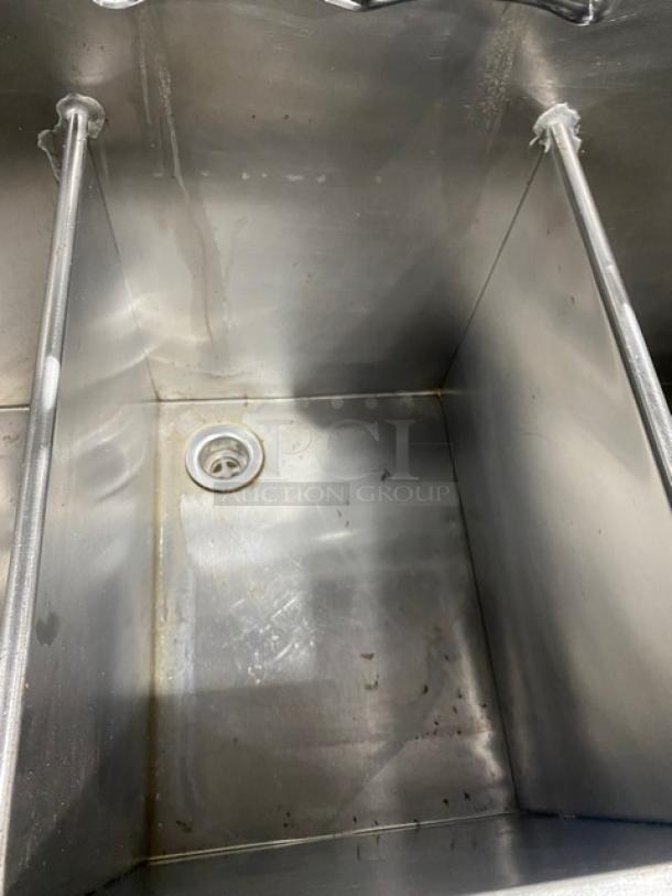 Commercial stainless steel 3-compartment prep sink with backsplash, swivel swing-spout faucet, on legs, visible drain.
