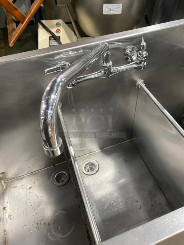 Commercial stainless steel 3-compartment prep sink with backsplash and swivel swing-spout faucet. Features robust legs, good condition.