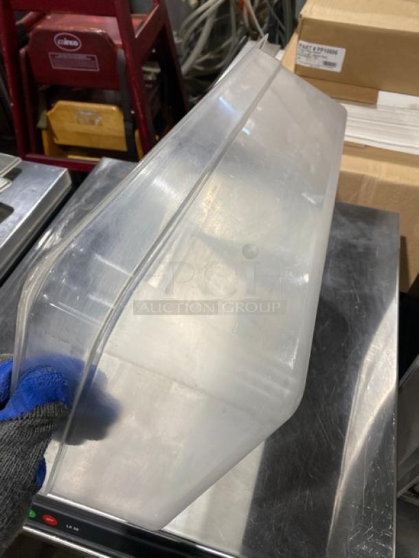 Cambro clear polycarbonate food pan, commercial grade, angled view showing depth and transparency, good condition.