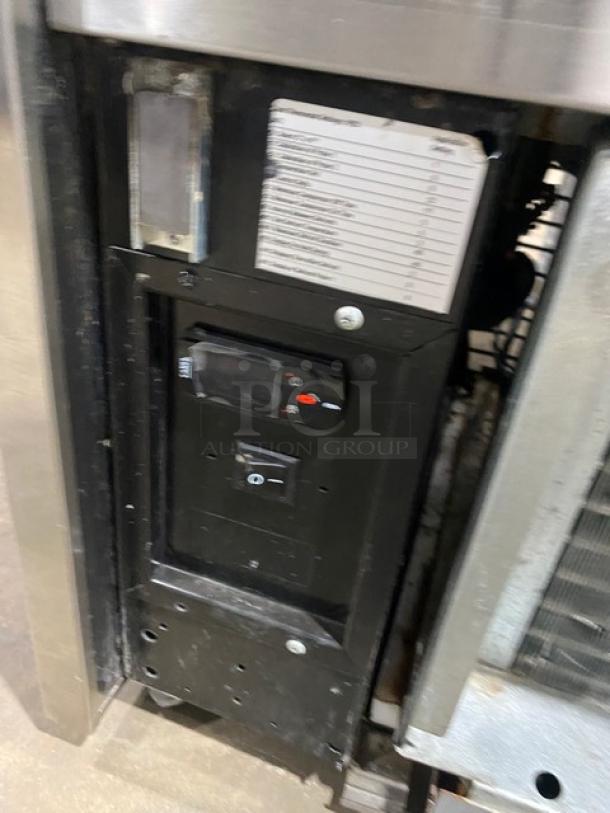 Structural Concepts Oasis Series B42 commercial stainless steel refrigerated display case control panel. Model and serial number tags visible.
