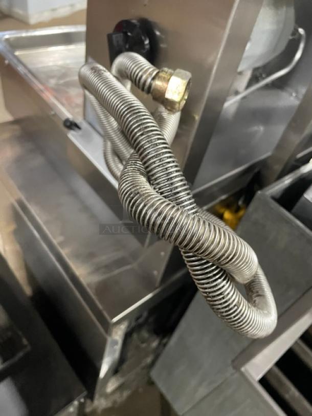 Atalay commercial stainless steel gyro machine, natural gas powered, with 3 burners and individual controls.