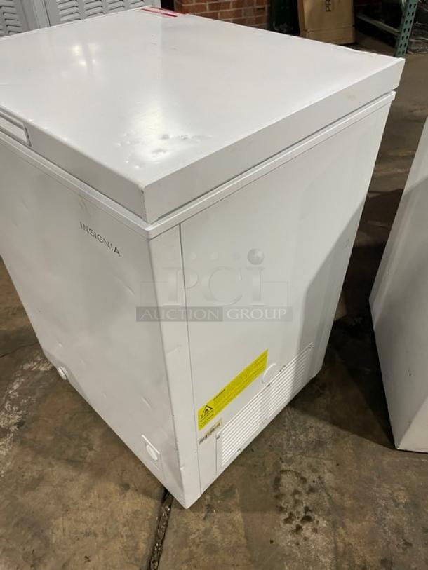 Insignia 25" white free-standing chest freezer, Model NS-CZ50WH0. Features visible vents and label, in good condition.