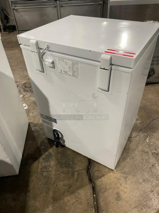 Insignia NS-CZ50WH0 commercial white 25" chest freezer, free-standing, 115V, top latches, slight wear, visible model label.