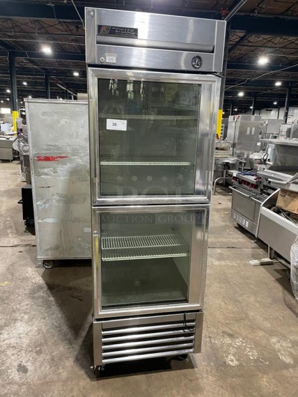 True T-23G-2 stainless steel merchandiser fridge with double glass half doors, poly-coated wire racks, on casters, model T23G2.