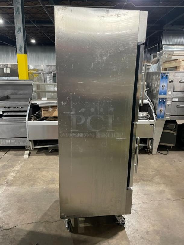 True T-23G-2 commercial refrigerator, stainless steel, double glass half doors, poly-coated wire racks, on casters, good condition.
