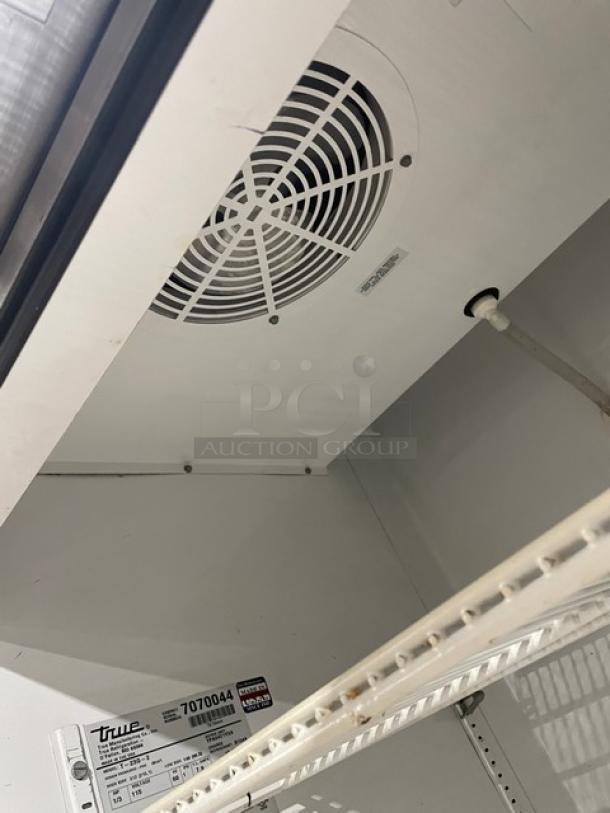 True T-23G-2 commercial stainless steel reach-in refrigerator, double glass half doors, poly coated wire racks, on casters.