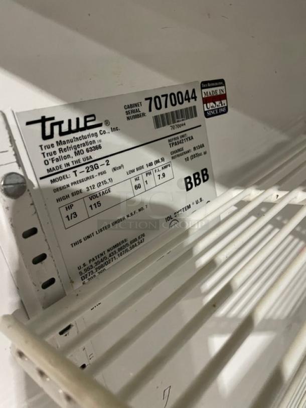 True commercial fridge model T-23G-2, stainless steel, double glass half doors, poly-coated racks, on casters, 115V.