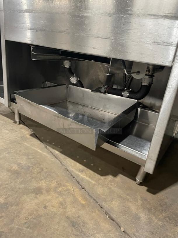 Custom commercial stainless steel double compartment sink workstation with goose neck swivel faucet, enclosed cabinet base, on legs.