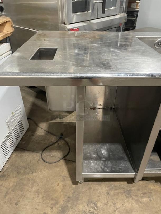 Custom stainless steel double compartment sink workstation with goose neck swivel faucet, enclosed cabinet base, on legs.