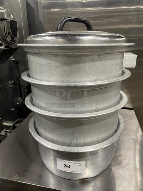 Vintage commercial aluminum rice cooker set with cover, stackable pots, label indicating item 38, visible wear marks.