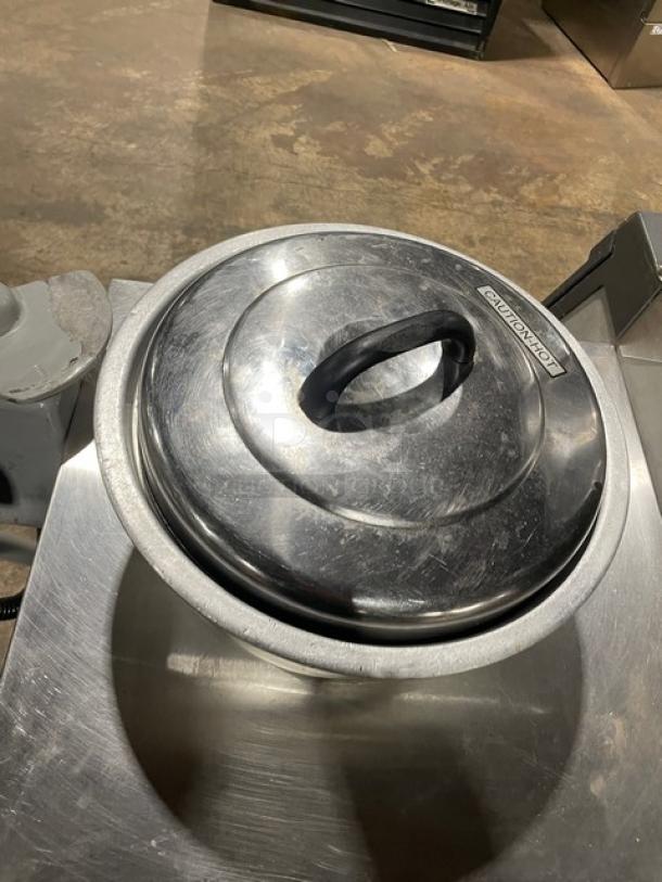 Vintage commercial aluminum rice cooker with cover, visible "CAUTION" label, used condition, metallic finish.