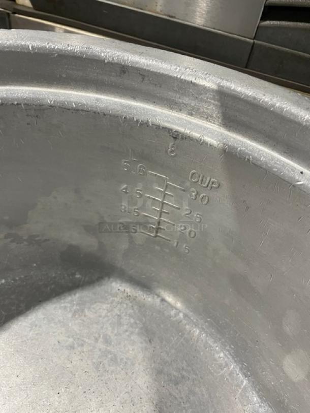 Vintage commercial aluminum rice cooker with cover, featuring measuring marks indicating capacity. Good condition.
