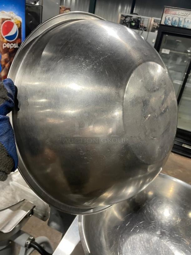 Stainless steel commercial round mixing bowl, lightly used, shiny finish, minor surface scratches, perfect for kitchen use.