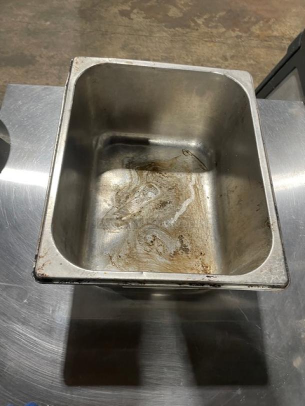 Stainless steel hotel steamtable pan, used condition with visible wear and residue, suitable for commercial kitchen needs.