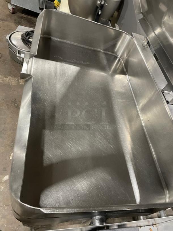 Groen commercial stainless steel gas-powered ultra tilt skillet on legs, featuring a large basin for versatile cooking.