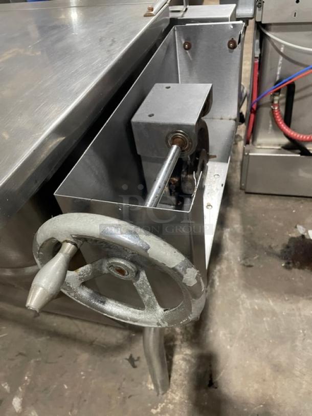 Groen commercial stainless steel natural gas-powered ultra tilt skillet with manual tilt handle. Mounted on sturdy legs.