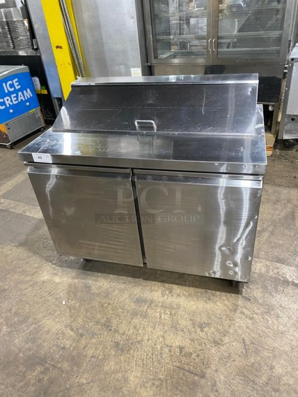 Commercial stainless steel 2-door refrigerated prep table, Model SCL2E. Features poly coated wire rack, casters, 115V. Serial: 6532423616110501.