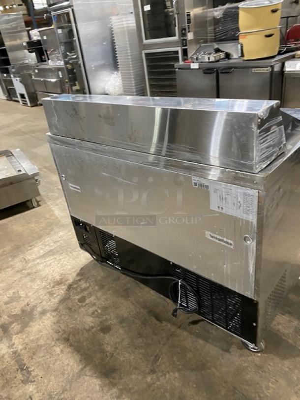 Commercial stainless steel 2-door refrigerated bain marie prep table, model SCL2E, on casters, with poly coated wire rack.