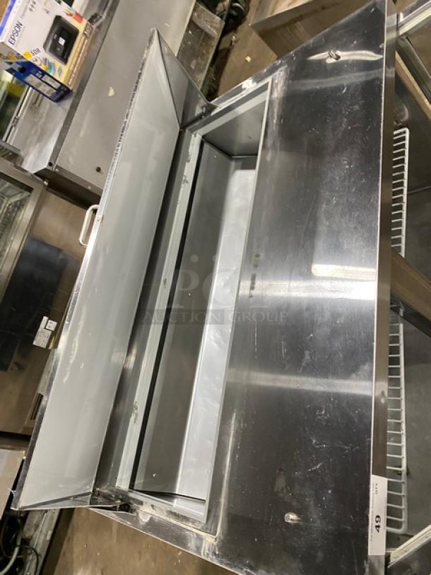 Commercial stainless steel 2-door refrigerated bain marie style prep table with wire rack, Model SCL2E, on casters.