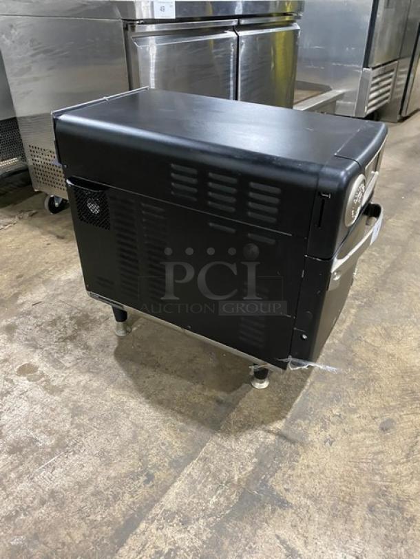 TurboChef NGO 2022 black countertop cook press edition oven, ventless, electric, with crank bar, 208/240V, 1 phase, on legs.