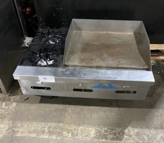 Comstock Castle FHP36-24 stainless steel countertop 2-burner split top griddle with back and side splash, natural gas, on legs.