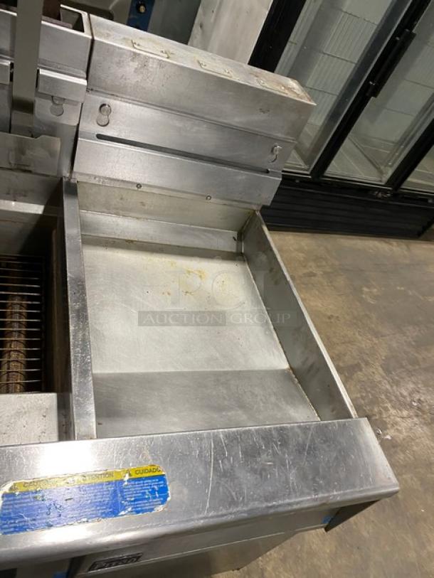 Pitco Frialator SG18JS 4-bay deep fryer, stainless steel, gas-powered, with filter pan and digital controls, on casters.
