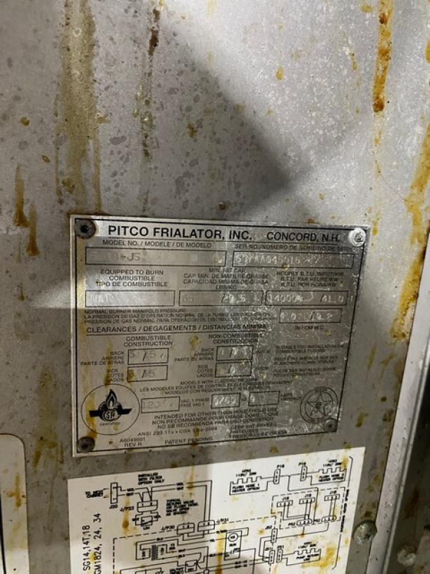 Pitco Frialator Series stainless steel 4-bay deep fat fryer system label. Model SG18-JS, natural gas, SN: G07AA045016, on casters.