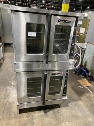 Garland Master Series stainless steel double stacked convection oven, natural gas powered, with thermostatic controls, wired racks, on casters.