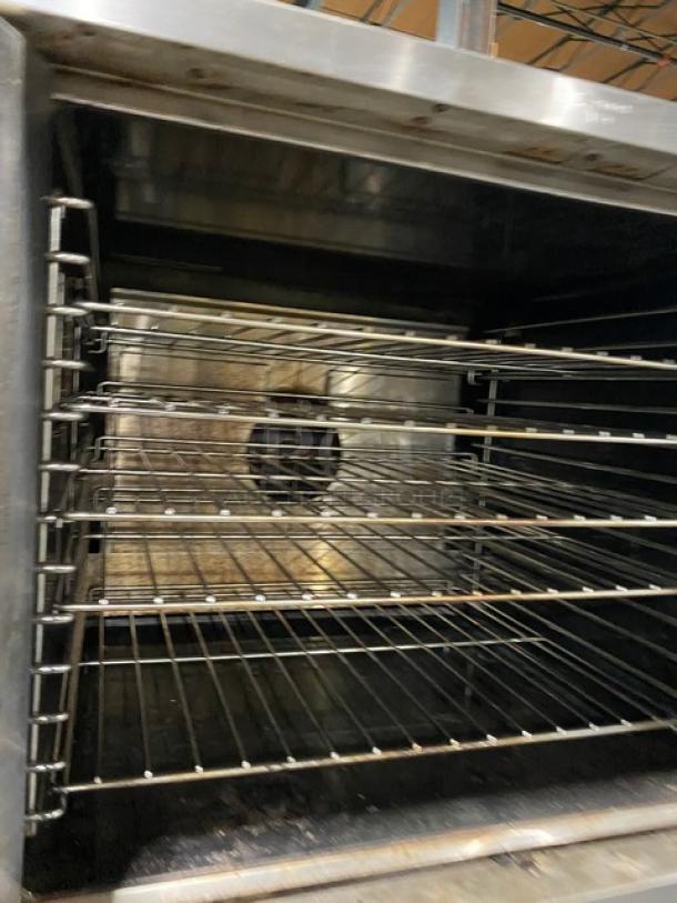 Garland Master Series double-stacked stainless steel convection oven with wired racks and thermostatic controls, on casters.