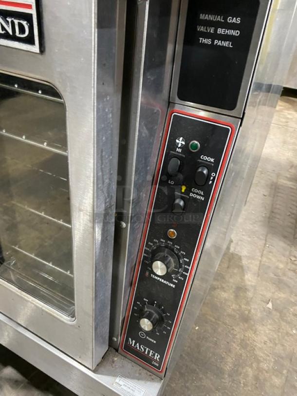 Garland Master Series stainless steel double stacked convection oven, natural gas, thermostatic controls, wired racks, on casters.