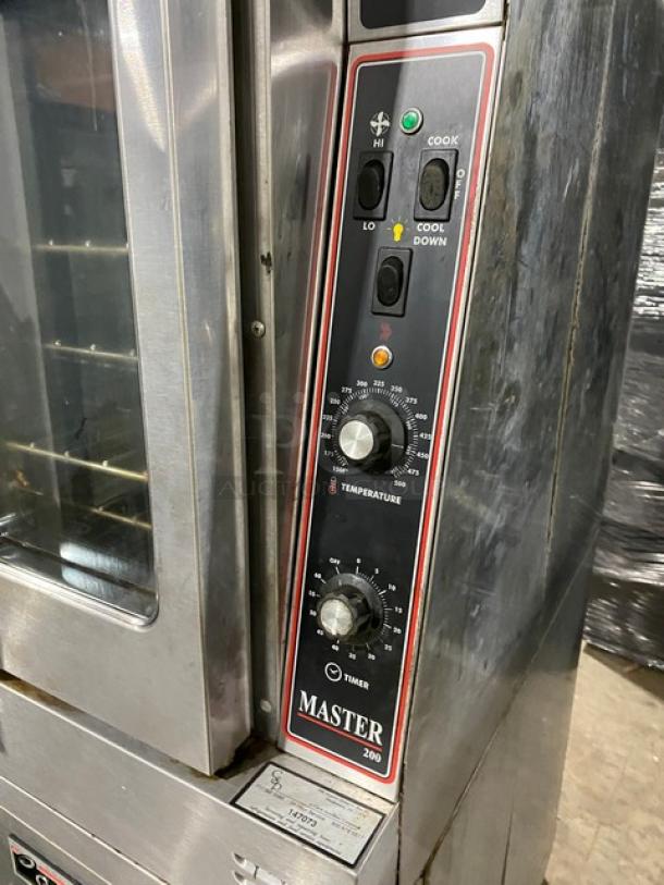 Garland Master Series commercial double-stacked stainless steel convection oven, natural gas, thermostatic controls, wired racks, on casters.