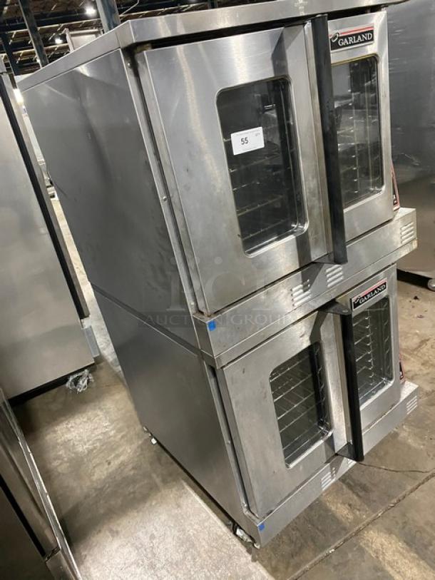 Garland Master Series stainless steel double stacked convection oven, natural gas, with thermostatic controls, wired racks, on casters.