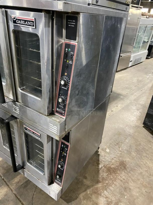 Garland Master Series stainless steel double stacked convection oven, natural gas, thermostatic controls, wired racks, on casters.