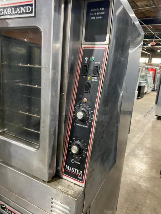 Garland Master Series stainless steel double stacked convection oven, natural gas, thermostatic controls, wired racks, on casters.