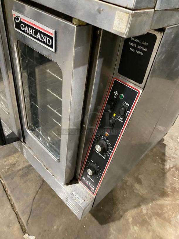 Garland Master Series stainless steel double convection oven, thermostatic controls, wired racks, on casters, good condition.