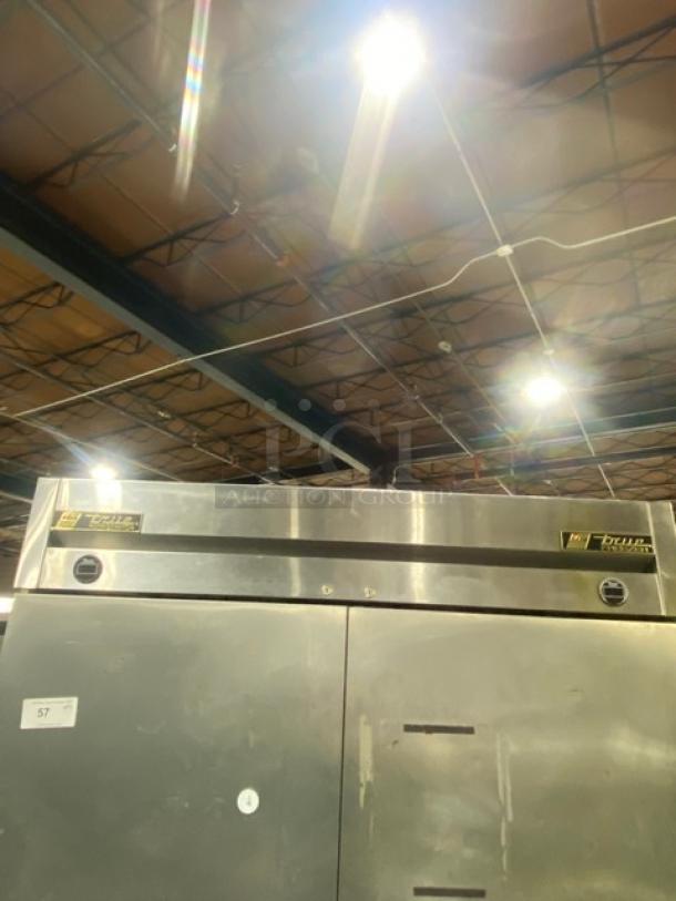 True T49DT stainless steel 2-door reach-in fridge/freezer combo. Features poly coated wire racks, model SN: 7681786, on casters.