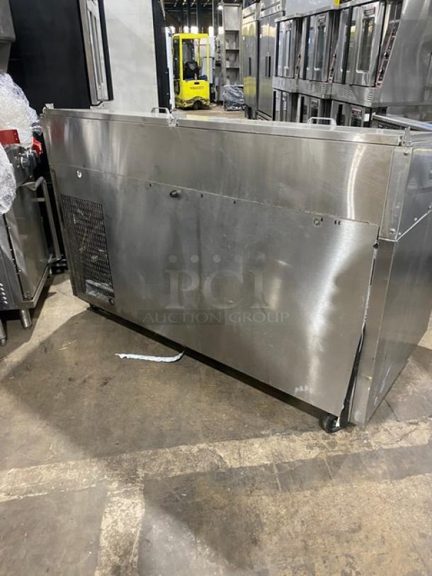 Continental stainless steel 2-door pizza prep table, model CPT67SS, on casters, with backsplash and poly-coated wire racks.