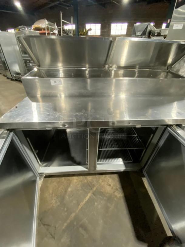 Continental CPT67-SS stainless steel refrigerated pizza prep table with backsplash, poly coated wire racks, on casters, open doors.