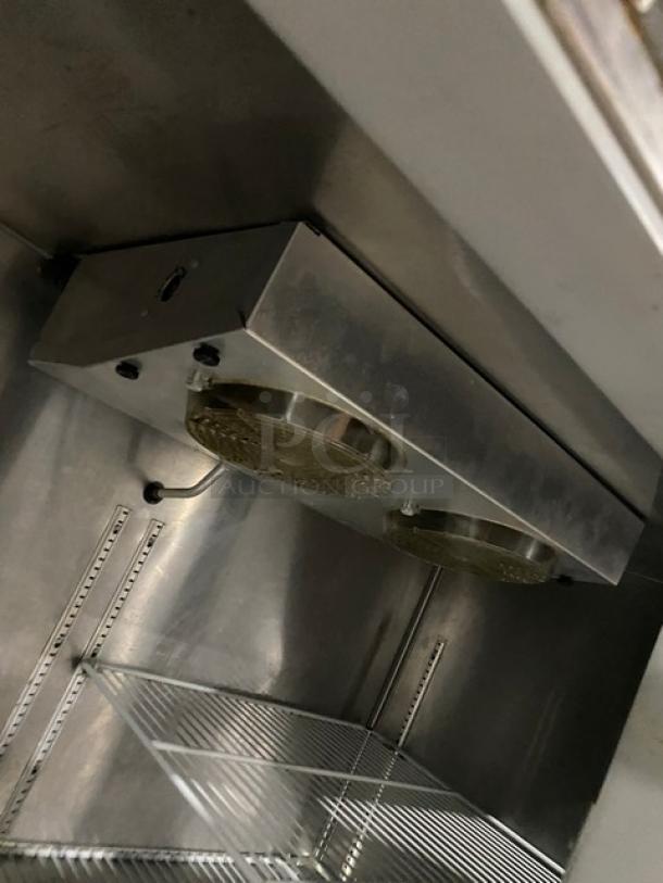 Continental Commercial Stainless Steel 2 Door Refrigerated Pizza Prep Table, Model CPT67SS, with back splash and poly-coated wire racks, on casters.