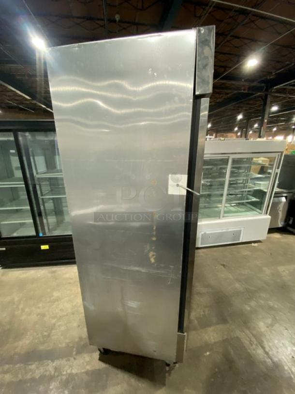 True T-23F commercial stainless steel single door reach-in freezer, on casters, poly-coated wire rack, visible wear.