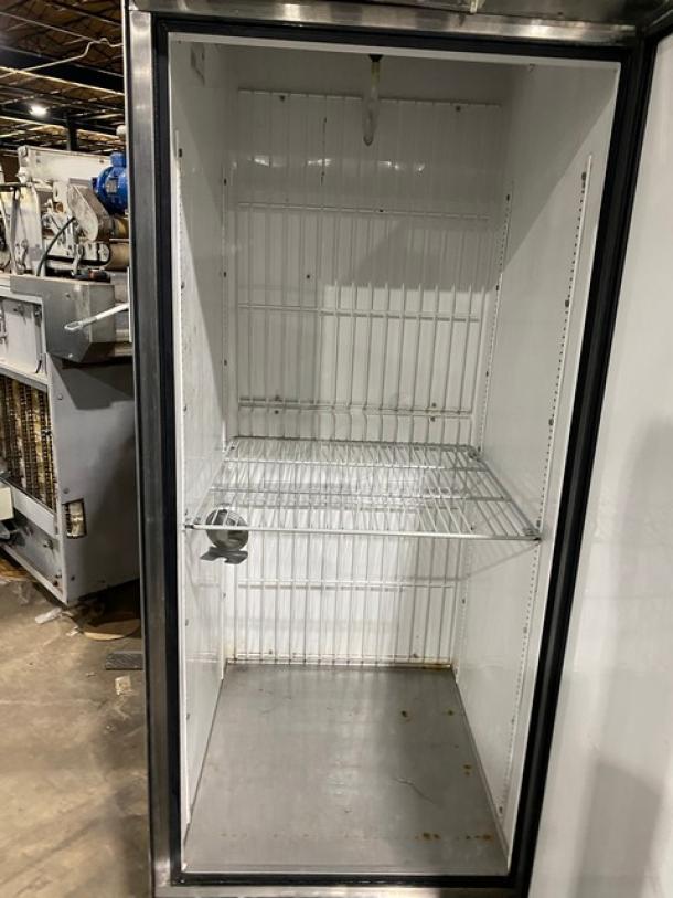 True T-23F commercial stainless steel single door reach-in freezer, featuring a poly-coated wire rack, on casters.