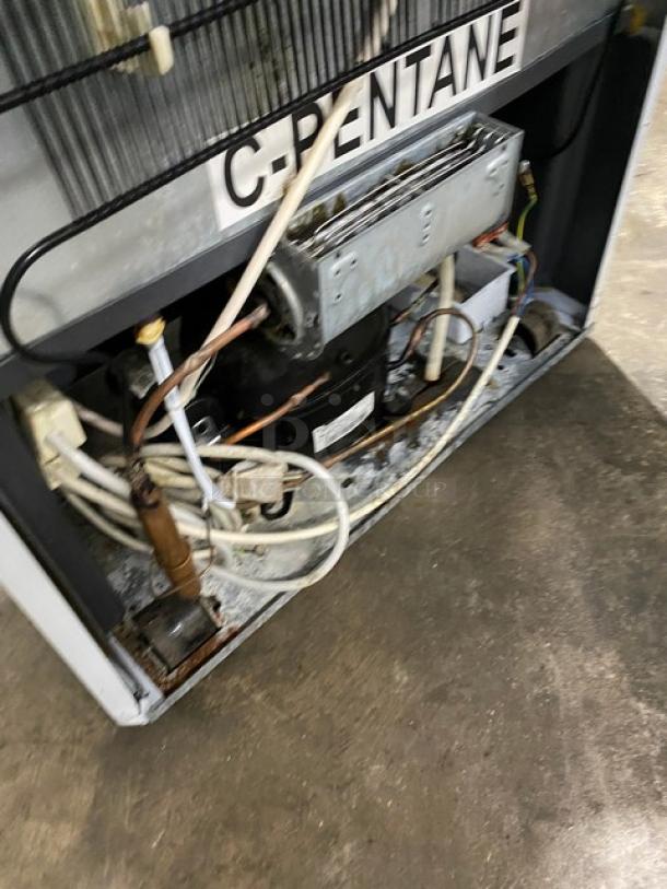 SLK Cooling commercial refrigerator, Model 374 Canopy. Reach-in with a single glass door, poly-coated wired rack, 115V. Visible wiring and C-Pentane label.