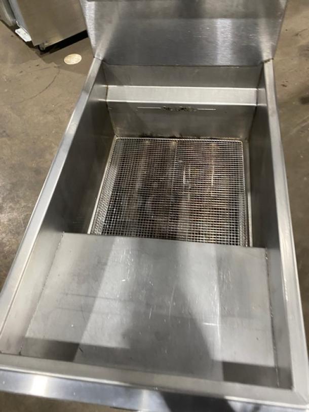 Imperial stainless steel natural gas deep fat fryer with back splash, basket hanger, and casters. Good condition.