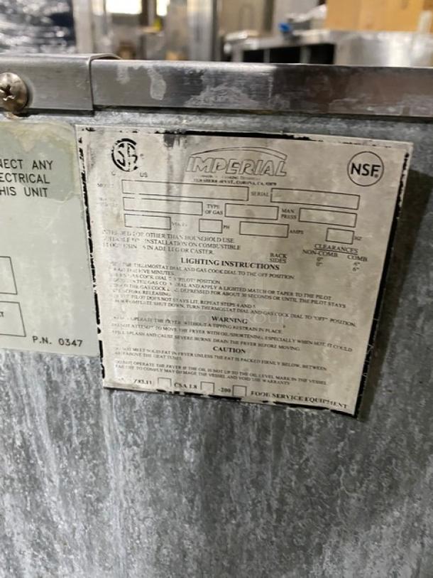 Imperial commercial stainless steel natural gas deep fat fryer with back splash, basket hanger, and casters. Features NSF label.
